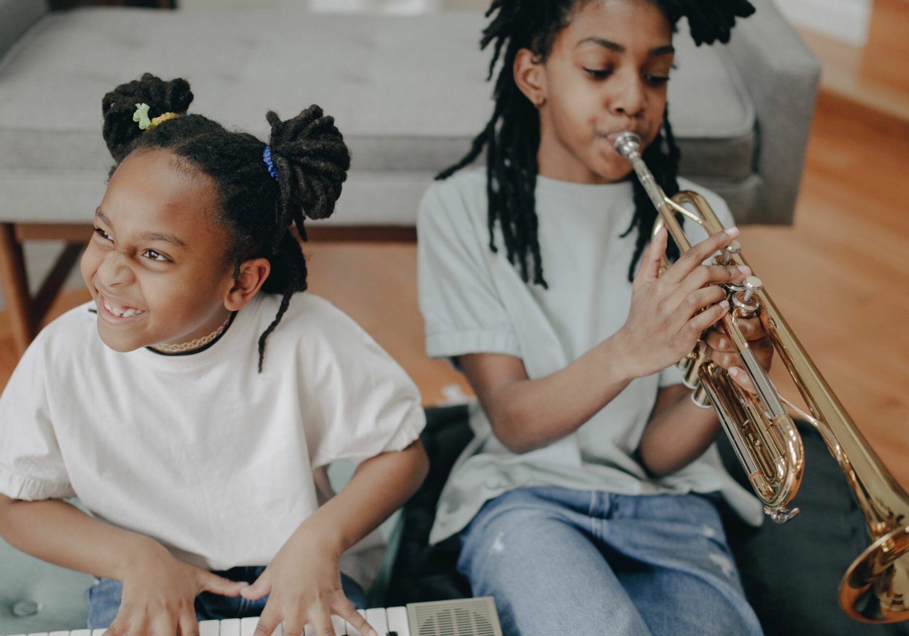 Children learning to play Piano in a music class for ages 5-12.